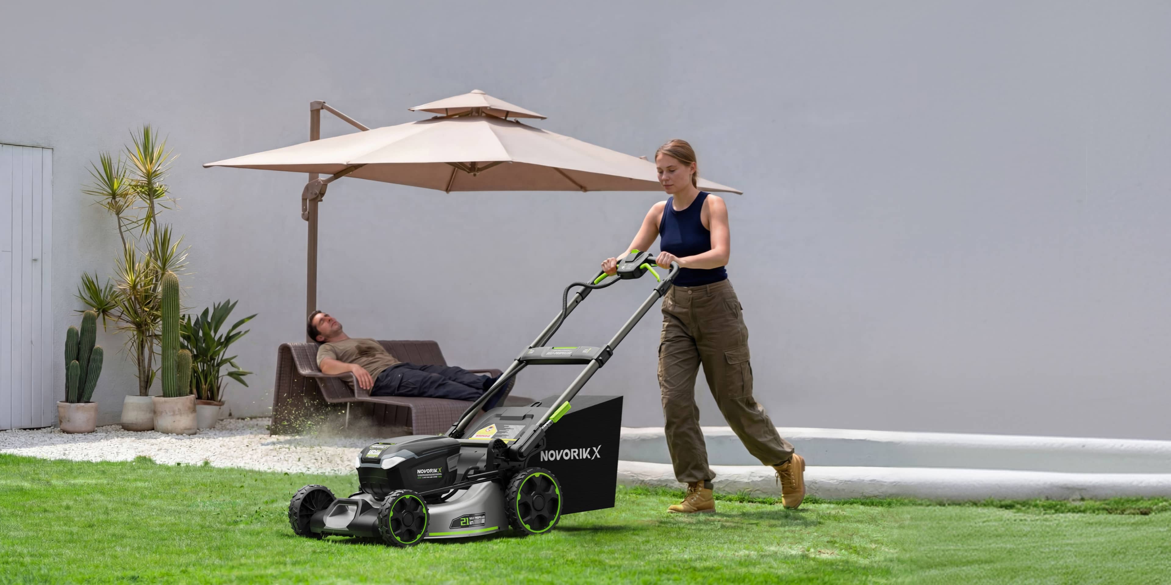 Quiet battery mower operating beside a patio